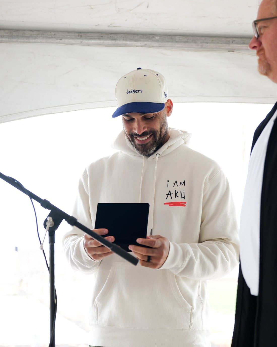 Reading the dedication under the tent