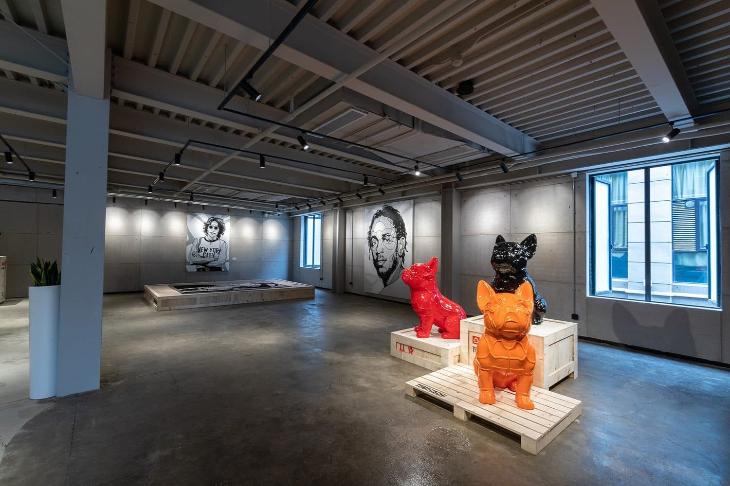 David Flores Tomodachi sculptures beside portrait works in the gallery