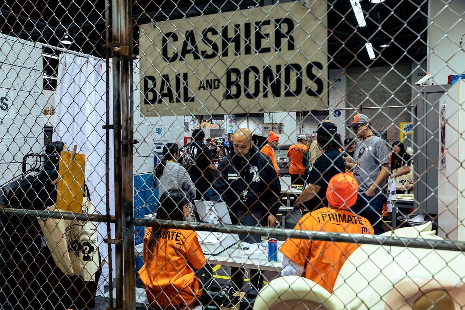 The caged ‘Cashier, Bail and Bonds’ checkout, staffed in prison orange.