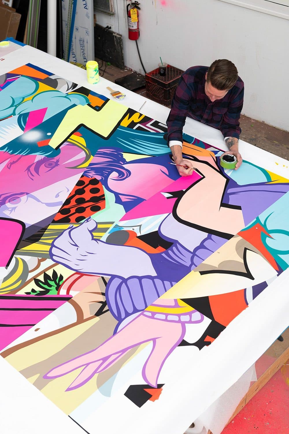 An artist at work on a commissioned canvas